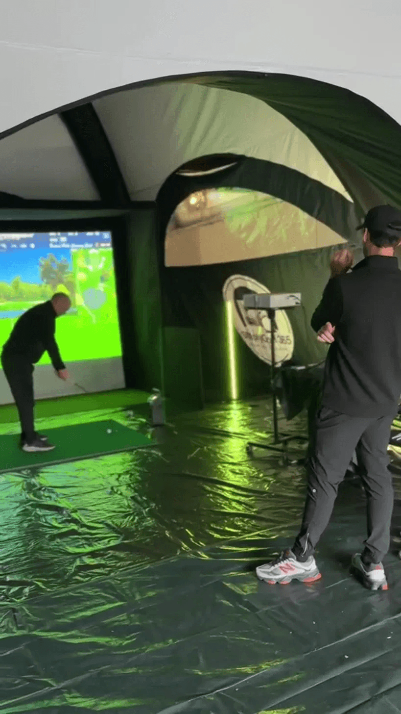 Coach and customer mid-round on the simulator